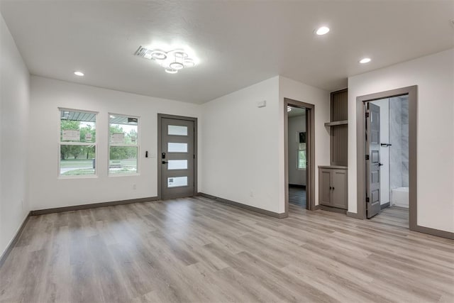 foyer with baseboards, recessed lighting, and light wood finished floors