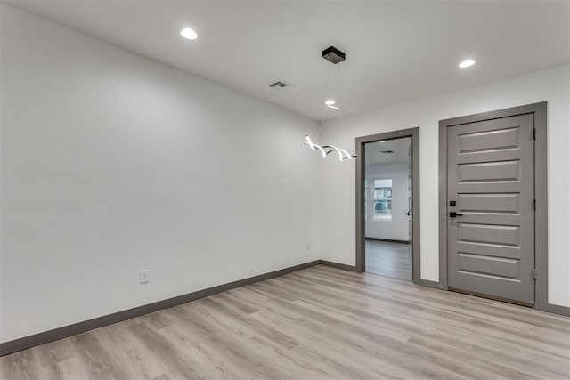 empty room with recessed lighting, baseboards, visible vents, and light wood-style flooring