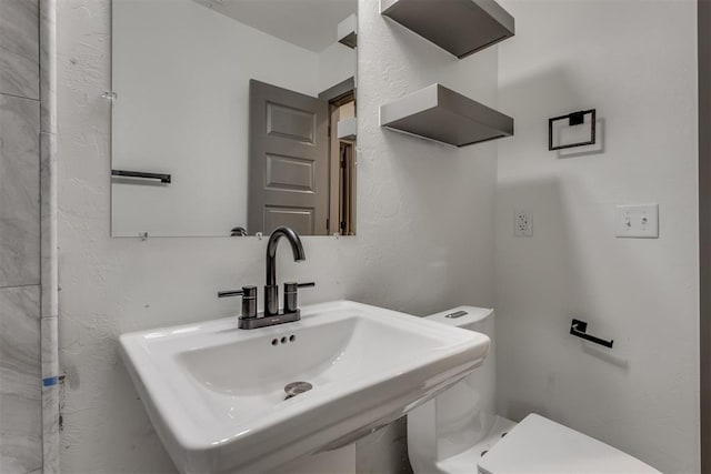 bathroom with toilet and a sink