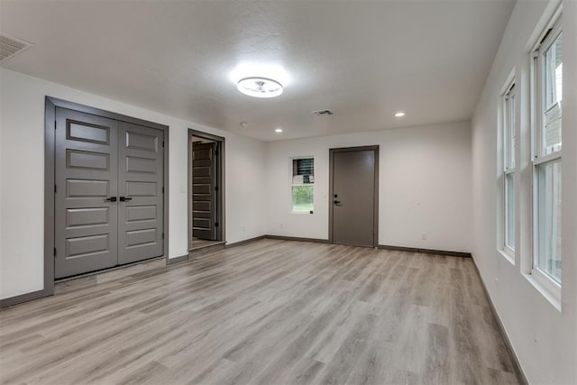 interior space featuring visible vents, recessed lighting, light wood-style flooring, and baseboards