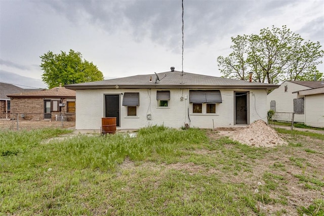 back of house with fence and brick siding