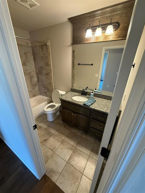 full bath featuring visible vents, tile patterned flooring, vanity, tub / shower combination, and toilet