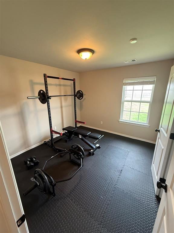 workout area featuring baseboards and visible vents