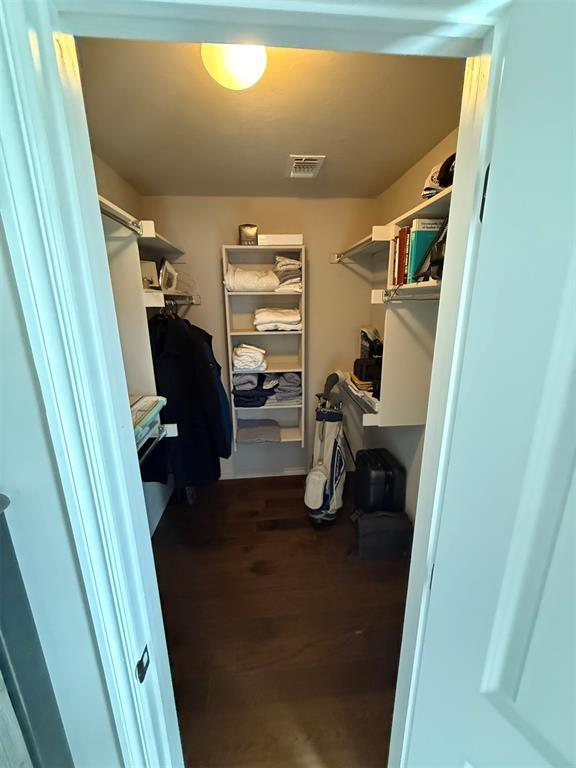 walk in closet with wood finished floors and visible vents