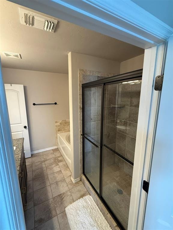 full bath with baseboards, visible vents, a bath, and a stall shower