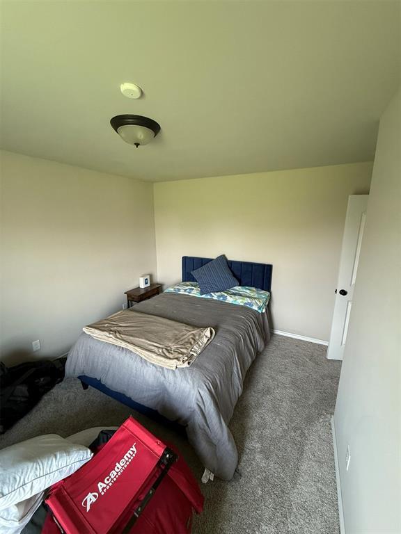 carpeted bedroom featuring baseboards