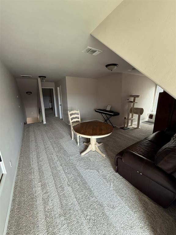 living room with visible vents, carpet flooring, and baseboards