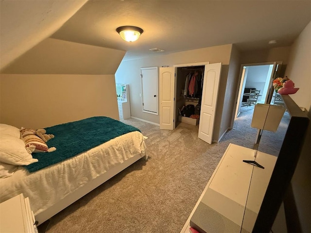 bedroom with visible vents, a closet, lofted ceiling, baseboards, and carpet