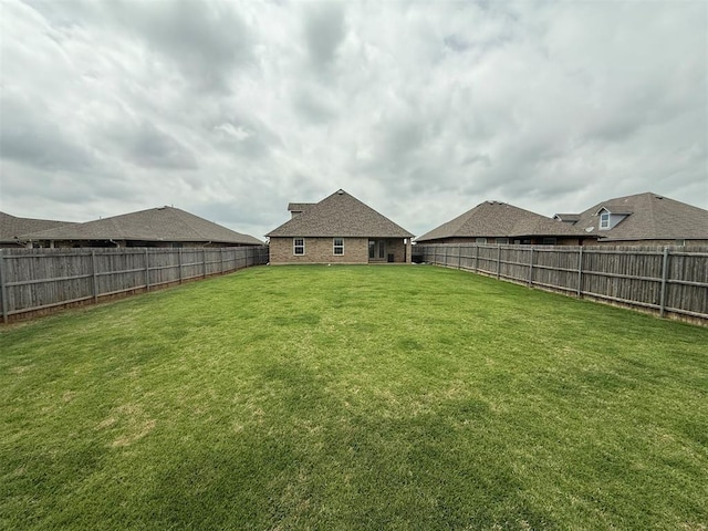 view of yard with a fenced backyard
