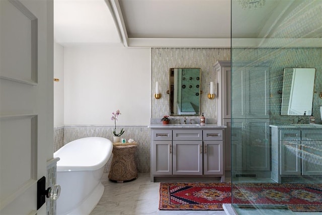 bathroom with vanity, a freestanding tub, marble finish floors, a wainscoted wall, and a shower with shower door