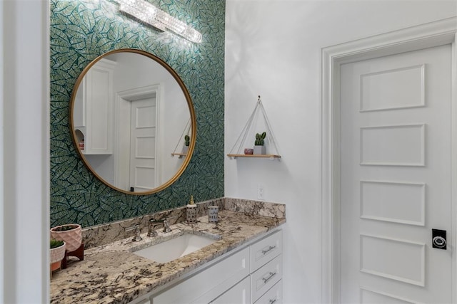 bathroom featuring wallpapered walls and vanity