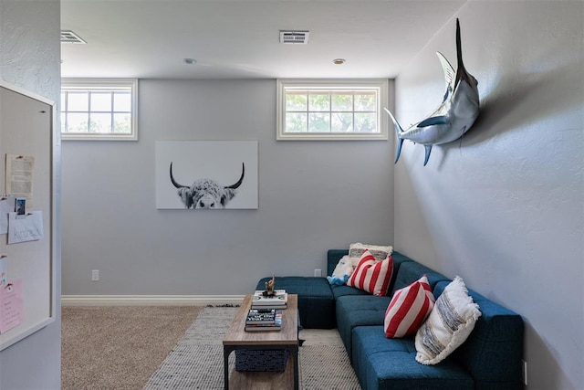 carpeted living room featuring healthy amount of natural light and baseboards