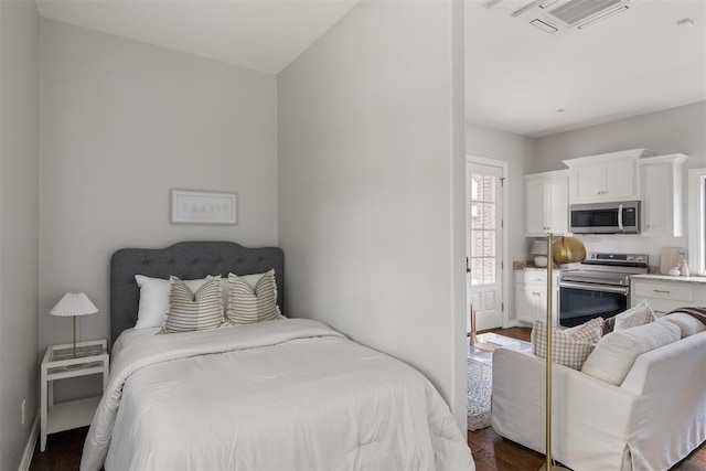 bedroom featuring dark wood-style floors and baseboards