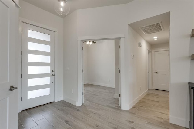entryway featuring visible vents, light wood-style floors, and baseboards