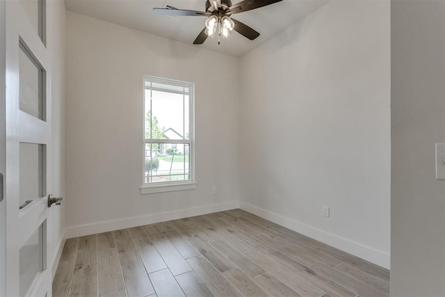 empty room with ceiling fan, baseboards, and light wood-type flooring