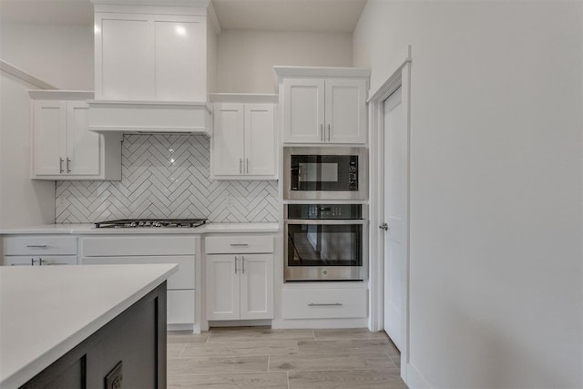 kitchen featuring light countertops, stainless steel oven, gas cooktop, and built in microwave