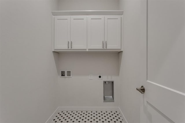 washroom featuring cabinet space, washer hookup, hookup for an electric dryer, and baseboards