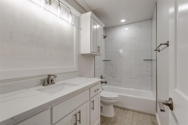 full bathroom featuring vanity, recessed lighting, washtub / shower combination, and toilet