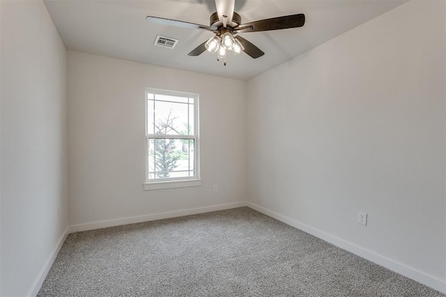 empty room featuring a ceiling fan, baseboards, visible vents, and carpet