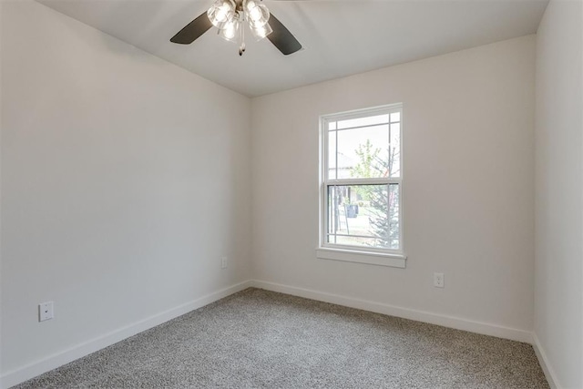 unfurnished room with baseboards, a ceiling fan, and light carpet