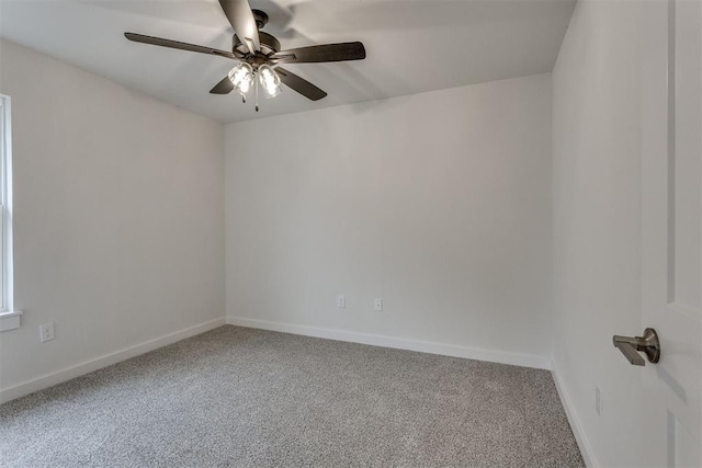 carpeted empty room featuring baseboards and ceiling fan