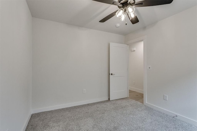 spare room featuring carpet floors, ceiling fan, and baseboards