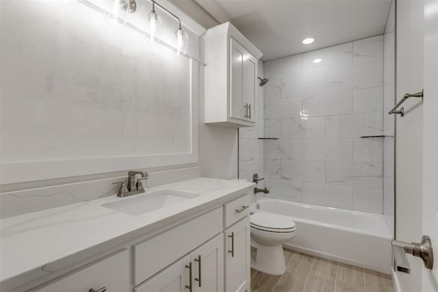full bathroom with vanity, bathtub / shower combination, toilet, recessed lighting, and wood finished floors