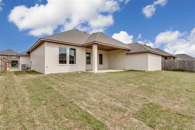 back of house featuring a yard, a patio, fence, and central AC unit