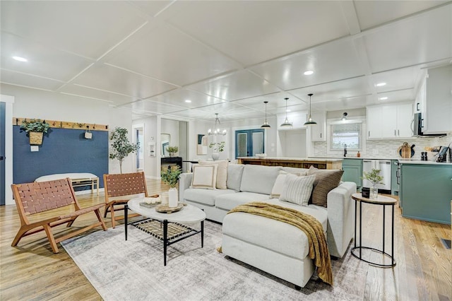 living area featuring recessed lighting, light wood-type flooring, and coffered ceiling