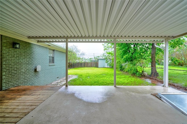 view of patio / terrace featuring a storage shed, an outdoor structure, and a fenced backyard