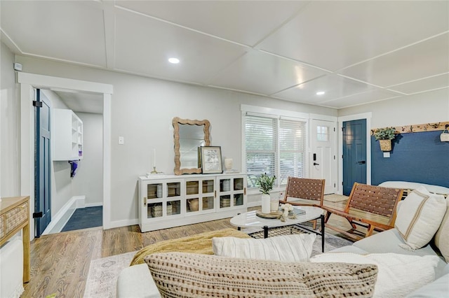 living room with recessed lighting, baseboards, and wood finished floors