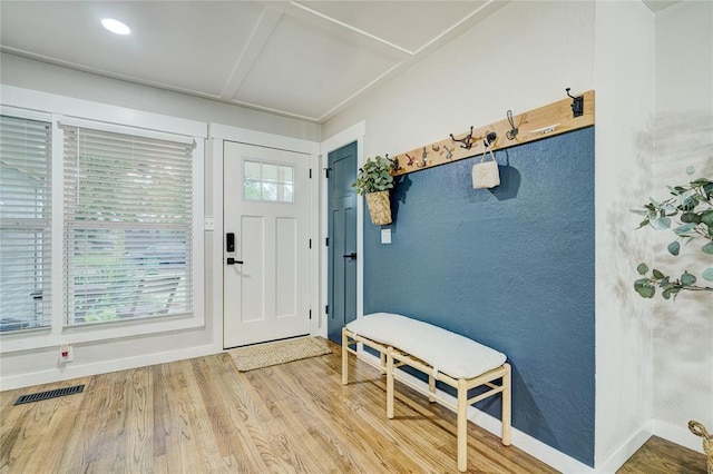 entryway featuring visible vents, baseboards, and wood finished floors