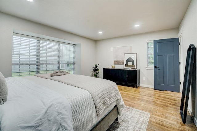 bedroom with recessed lighting, baseboards, multiple windows, and light wood finished floors
