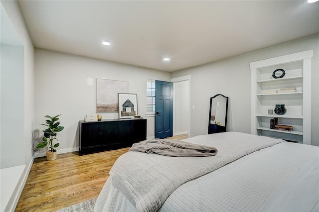 bedroom featuring light wood-type flooring, recessed lighting, and baseboards