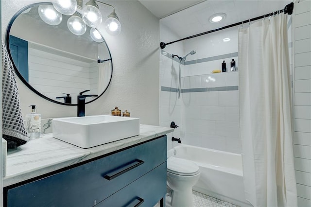 full bathroom with vanity, tile patterned flooring, a textured wall, shower / bath combination with curtain, and toilet