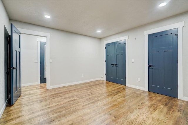 empty room with recessed lighting, baseboards, and light wood-type flooring
