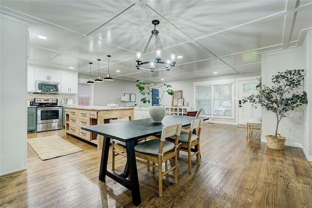 46 E 14th St, Edmond, OK 73034 - dining room featuring light wood-type flooring, a chandelier, recessed lighting, and baseboards