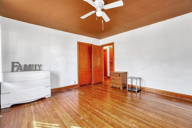 bedroom with baseboards, a ceiling fan, and wood finished floors