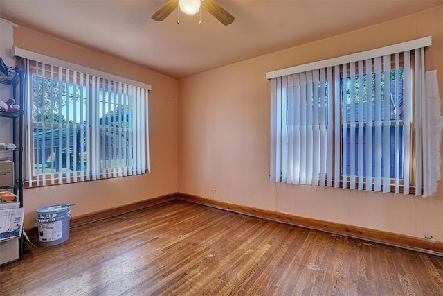 unfurnished room featuring wood-type flooring, baseboards, and ceiling fan