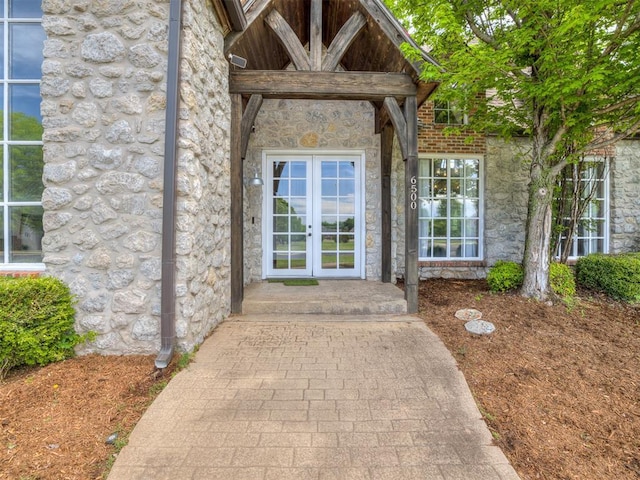 doorway to property with french doors and stone siding
