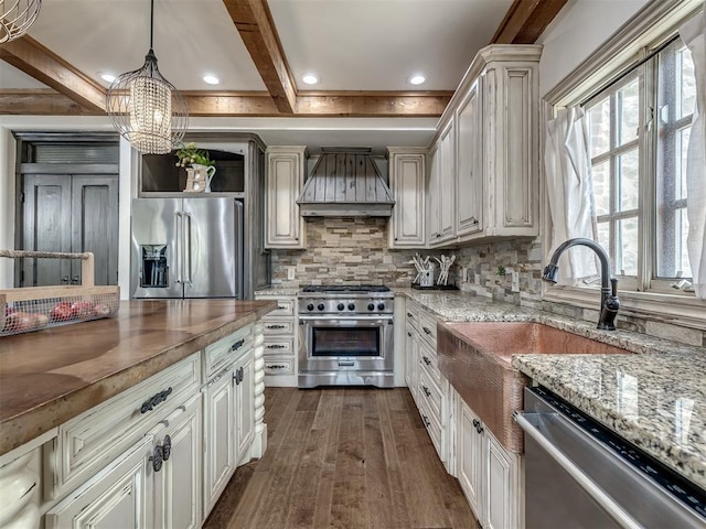 kitchen with decorative backsplash, high end appliances, dark wood finished floors, beam ceiling, and premium range hood