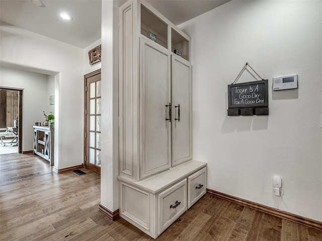 mudroom with baseboards and light wood finished floors