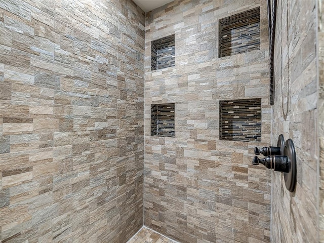 bathroom with a tile shower