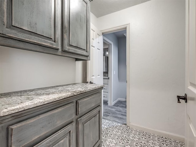 bathroom with baseboards and tile patterned floors