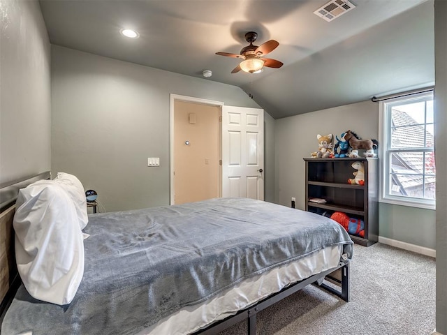 bedroom featuring ceiling fan, visible vents, vaulted ceiling, carpet floors, and baseboards