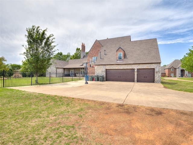 view of front of home with fence, a front lawn, stone siding, a garage, and a chimney