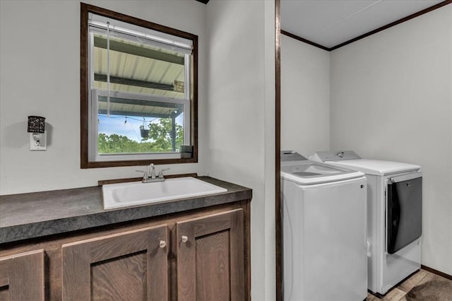 25386 Patterson Rd, Tecumseh, OK 74873 - laundry area featuring washer and dryer, cabinet space, and crown molding