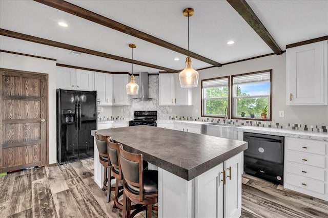 25386 Patterson Rd, Tecumseh, OK 74873 - kitchen with wall chimney exhaust hood, black appliances, light wood-style flooring, beamed ceiling, and a sink