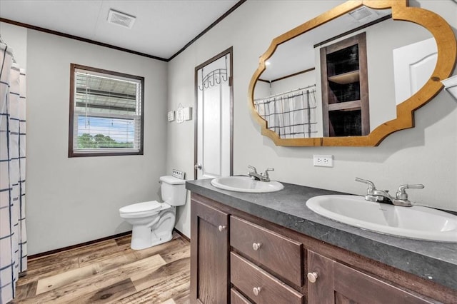 25386 Patterson Rd, Tecumseh, OK 74873 - bathroom with wood finished floors, double vanity, toilet, a shower with shower curtain, and crown molding