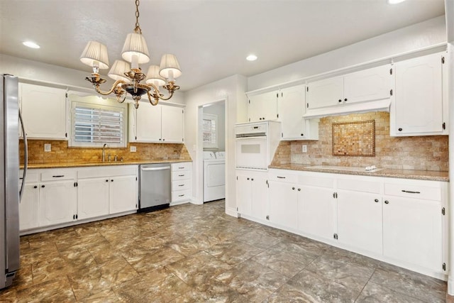 kitchen with a sink, appliances with stainless steel finishes, recessed lighting, and white cabinetry